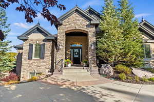 Doorway to property featuring stone siding