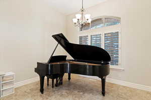 Sitting room with a chandelier and a high ceiling