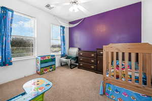 Bedroom with light carpet and ceiling fan