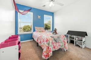 Bedroom with light colored carpet and ceiling fan