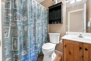 Bathroom with vanity, light tile patterned floors, and a shower with curtain