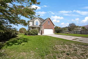 Traditional-style home featuring concrete driveway, covered porch, brick siding, a shingled roof, and a garage