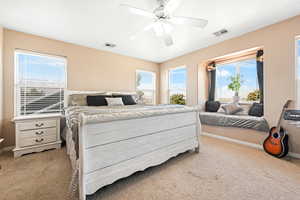 Bedroom featuring light colored carpet and a ceiling fan