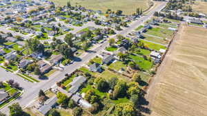 Aerial view of property and surrounding area with nearby suburban area