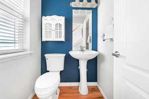 Bathroom with wood finished floors and baseboards