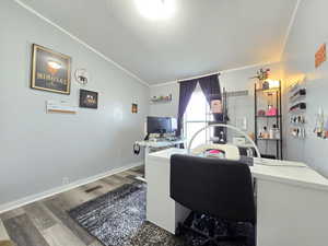 Home office with wood finished floors, a textured ceiling, and vaulted ceiling