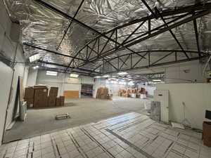 Misc room featuring metal wall and high vaulted ceiling