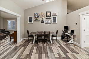 Dining space with vaulted ceiling and light wood finished floors