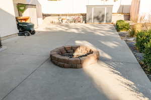 View of patio with an outdoor fire pit