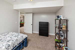 Bedroom with light colored carpet and baseboards