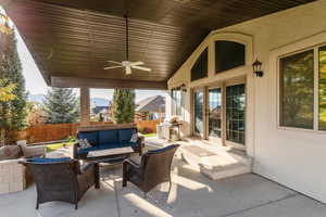 Fenced backyard with a ceiling fan, outdoor lounge area, and a patio area