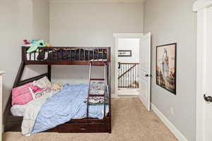Carpeted bedroom with baseboards
