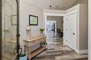 Hall featuring a textured wall and wood finished floors