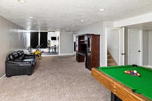 Game room featuring carpet, a textured ceiling, billiards, and recessed lighting