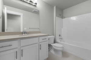 Full bathroom featuring bathtub / shower combination, vanity, and light tile patterned floors