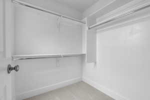 Walk in closet featuring light carpet