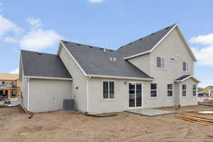 Back of property with a patio, a shingled roof, and stucco siding