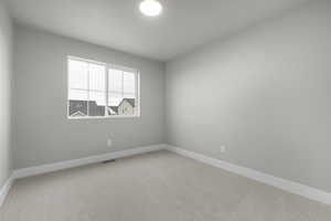Spare room with carpet floors and baseboards