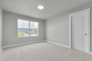 Spare room with carpet flooring and baseboards