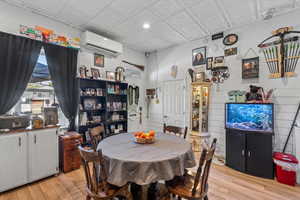 Dining space with light wood-style flooring and an ornate ceiling