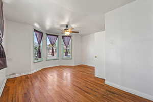 Unfurnished room featuring hardwood / wood-style floors and a ceiling fan