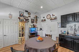 Dining space with light wood finished floors and an ornate ceiling