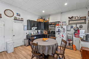 Kitchen with light wood-type flooring, recessed lighting, and black gas stove