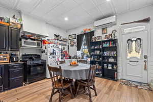 Dining space with light wood-style flooring, an ornate ceiling, and recessed lighting