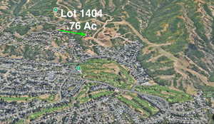 Aerial overview of property's location between golf course and National Forest.
