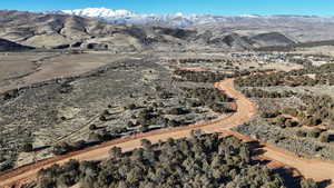 Aerial view of property's location featuring a mountainous background
