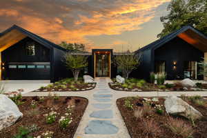 Contemporary home featuring concrete driveway and board and batten siding
