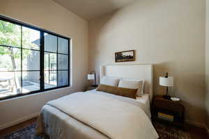 Bedroom featuring baseboards and wood finished floors