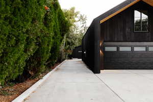 View of home's exterior featuring a garage and driveway