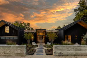 View of front of house featuring a metal roof, a standing seam roof, and a garage