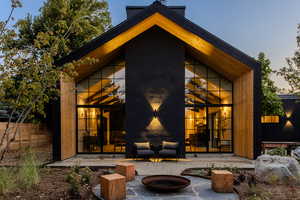 Rear view of property with a fire pit and a patio area