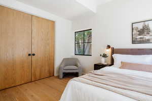 Bedroom with light wood-type flooring and a closet