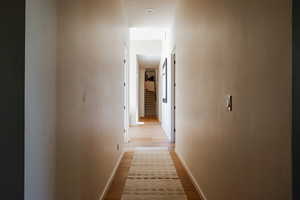 Corridor featuring light wood-style floors