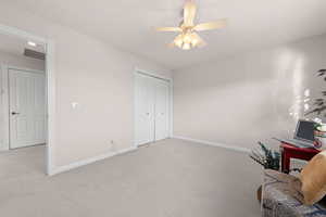 Office area featuring carpet flooring and a ceiling fan