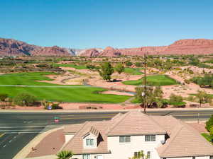 View of mountain backdrop with a golf club and a large body of water