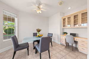 Dining room featuring healthy amount of natural light, ceiling fan, light tile patterned flooring, and recessed lighting