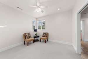 Living area with carpet, recessed lighting, and ceiling fan