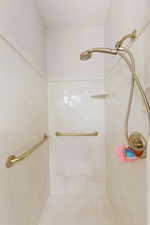 Bathroom featuring a marble finish shower