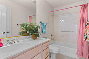 Bathroom with shower / bathtub combination with curtain and vanity