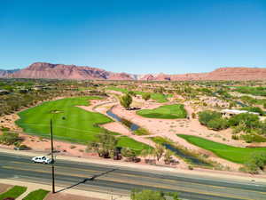 Drone / aerial view of a local golf course and a water and mountain view