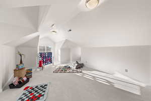 Bonus room featuring carpet floors and lofted ceiling
