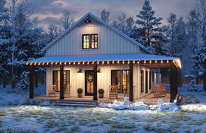 Snow covered house featuring board and batten siding, covered porch, and french doors