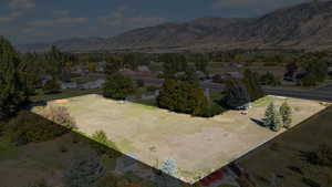 Aerial view of property and surrounding area with a mountainous background