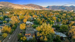 Aerial view of property and surrounding area featuring mountains
