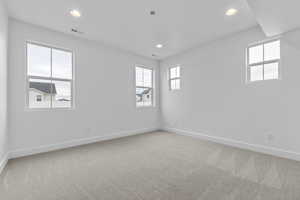 Empty room featuring light colored carpet and recessed lighting