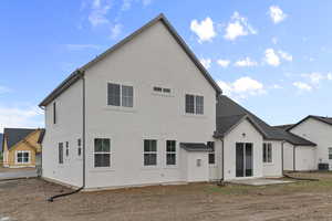 Back of property with a patio and stucco siding
